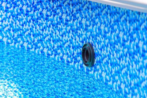 Close up view of blue mosaic pool liner with drainage opening in Virginia & Maryland