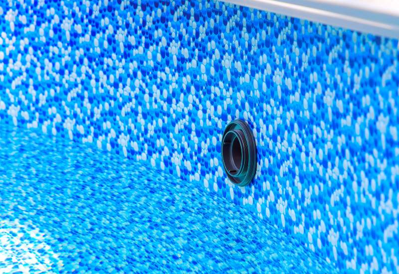 Close up view of blue mosaic pool liner with drainage opening in Virginia & Maryland