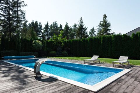Clean residential swimming pool with lounge chairs in Virginia & Maryland