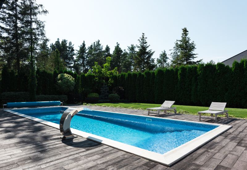 Clean residential swimming pool with lounge chairs in Virginia & Maryland
