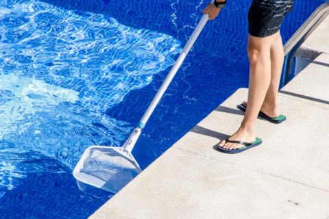 someone cleaning out pool