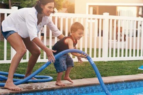 mom and son cleaning pool