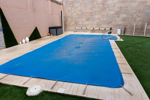 Small Pool Covered with a Blue Pool Cover During the Winter in Virginia & Maryland
