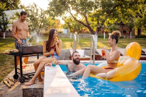 People Relaxing in a Residential Backyard Pool in Virginia & Maryland