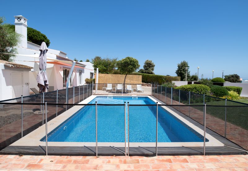 Fenced Outdoor Pool with Lounge Chairs in a Sunny Backyard in Virginia & Maryland