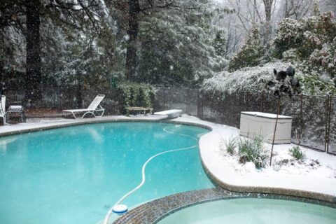 Snowy Backyard Pool with Lounge Chairs and Trees in Winter in Virginia & Maryland