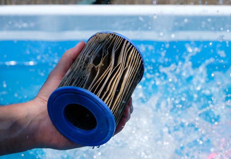 Pool Expert Holding a Dirty Pool Filter in Virginia & Maryland